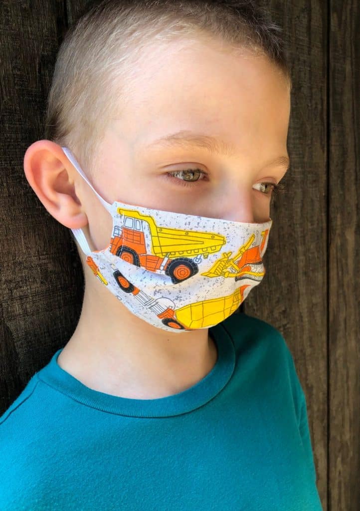 kid in mask with trucks on it